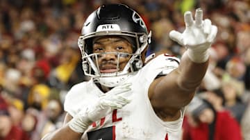 Dec 29, 2024; Landover, Maryland, USA; Atlanta Falcons running back Bijan Robinson (7) celebrates after scoring a touchdown against the Washington Commanders during the first half at Northwest Stadium. Mandatory Credit: Amber Searls-Imagn Images