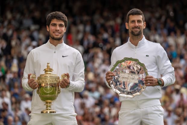 Carlos Alcaraz and Novak Djokovic pose with their trophies after Wimbledon.