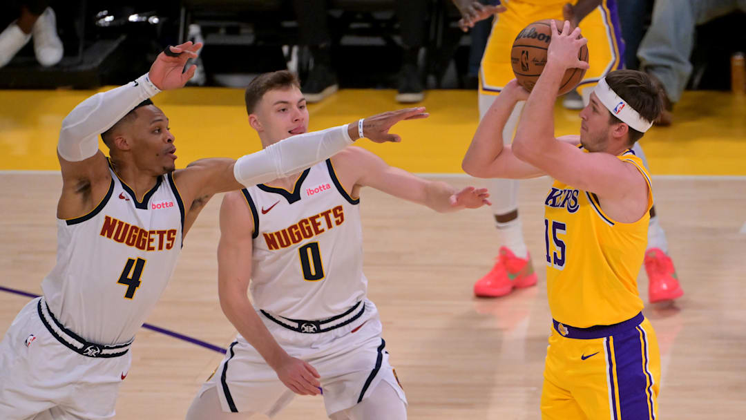 Mar 19, 2025; Los Angeles, California, USA; Denver Nuggets guard Russell Westbrook (4) and guard Christian Braun (0) defend as shot by Los Angeles Lakers guard Austin Reaves (15) in the first half at Crypto.com Arena. Mandatory Credit: Jayne Kamin-Oncea-Imagn Images