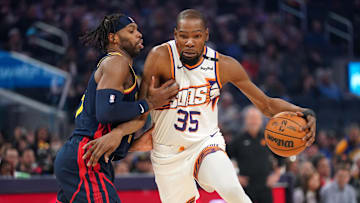 Jan 31, 2025; San Francisco, California, USA; Phoenix Suns forward Kevin Durant (35) dribbles the ball next to Golden State Warriors guard Buddy Hield (7) in the first quarter at the Chase Center.