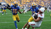 Sep 27, 2025; Pittsburgh, Pennsylvania, USA;  Louisville Cardinals tight end Nate Kurisky (85) catches a touchdown pass behind Pittsburgh Panthers defensive backs Rashad Battle (15) and Cruce Brookins (12) during the fourth quarter at Acrisure Stadium. Mandatory Credit: Charles LeClaire-Imagn Images