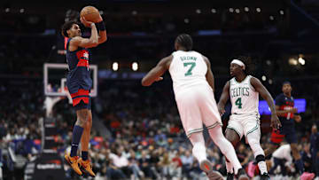 Nov 22, 2024; Washington, District of Columbia, USA; Washington Wizards guard Jordan Poole (13) shoots the ball as Boston Celtics guard Jaylen Brown (7) and Celtics guard Jrue Holiday (4) look on in the second half at Capital One Arena. Mandatory Credit: Geoff Burke-Imagn Images
