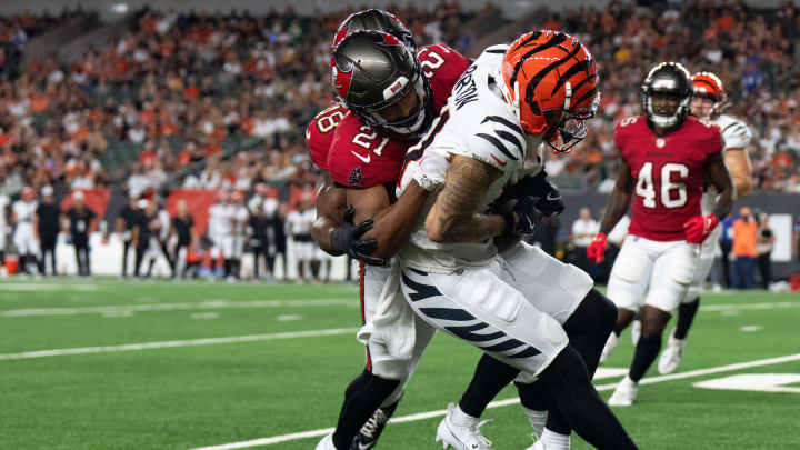 Tampa Bay Buccaneers corner back Andrew Hayes (21) tackles Cincinnati Bengals wide receiver Jermaine Burton (81) in the fourth quarter of the NFL preseason game at Paycor Stadium in Cincinnati on Saturday, August 10, 2024.