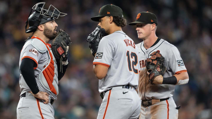 Aug 23, 2024; Seattle, Washington, USA; San Francisco Giants relief pitcher Jordan Hicks (12), catcher Curt Casali (2), left, and shortstop Tyler Fitzgerald (49) during the seventh inning against the Seattle Mariners at T-Mobile Park.