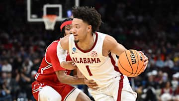 Mar 21, 2025; Cleveland, OH, USA; Alabama Crimson Tide guard Mark Sears (1) dribbles defended by Robert Morris Colonials guard DJ Smith (11) in the first half during the NCAA Tournament First Round at Rocket Arena. Mandatory Credit: Ken Blaze-Imagn Images