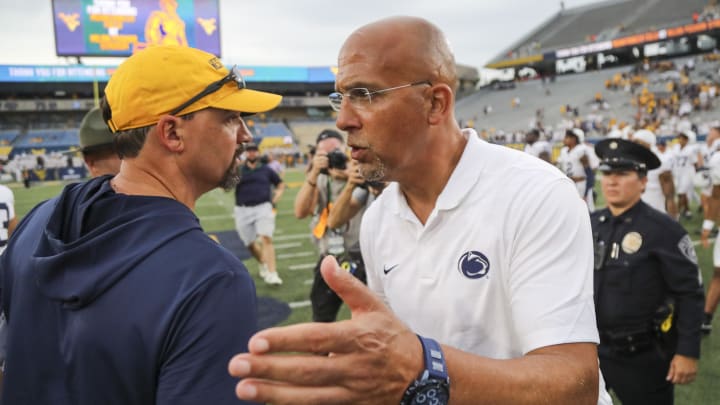 Penn State head coach James Franklin speaks with West Virginia Mountaineers head coach Neal Brown after the game at Mountaineer Field at Milan Puskar Stadium.