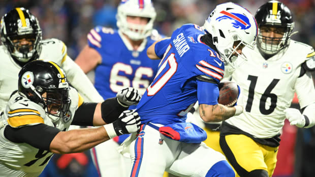 Jan 15, 2024; Orchard Park, New York, USA; Buffalo Bills wide receiver Khalil Shakir (10) runs the ball pressured by Pittsburgh Steelers defensive tackle Cameron Heyward (97) in a 2024 AFC wild card game at Highmark Stadium. Mandatory Credit: Mark Konezny-USA TODAY Sports