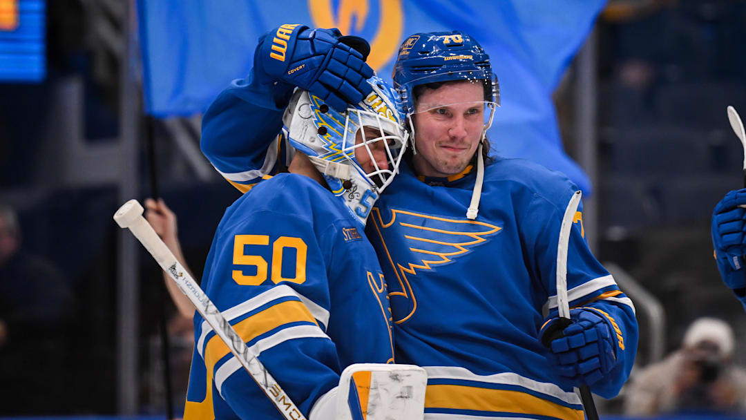 Apr 14, 2026; St. Louis, Missouri, USA; St. Louis Blues center Oskar Sundqvist (70) congratulates goaltender Jordan Binnington (50) after defeating the Pittsburgh Penguins at Enterprise Center. Mandatory Credit: Connor Hamilton-Imagn Images