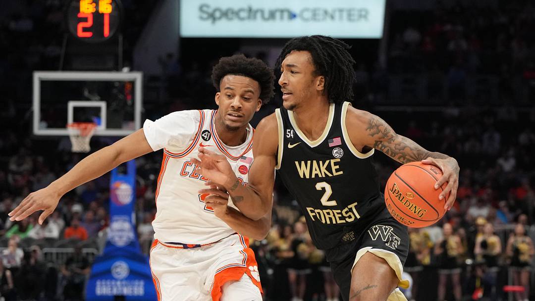 Mar 11, 2026; Charlotte, NC, USA; Wake Forest Demon Deacons forward Juke Harris (2) with the ball as Clemson Tigers guard Efrem Johnson (4) defends in the first half at Spectrum Center. Mandatory Credit: Bob Donnan-Imagn Images