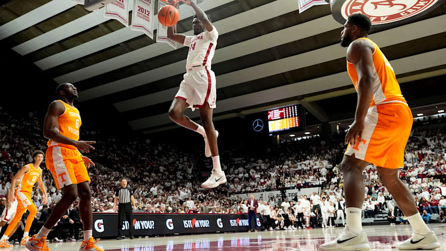 Alabama center Charles Bediako dunks the ball over Tennessee forward Dewayne Brown II on Saturday.