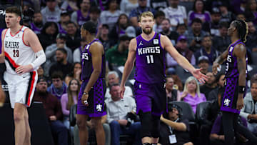 Oct 28, 2024; Sacramento, California, USA; Sacramento Kings center Domantas Sabonis (11) shakes hands with guard Keon Ellis (23) during the second quarter against the Portland Trail Blazers at Golden 1 Center. Mandatory Credit: Sergio Estrada-Imagn Images