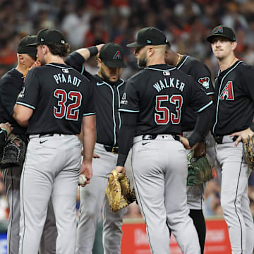 Sep 6, 2024; Houston, Texas, USA;   Arizona Diamondbacks starting pitcher Brandon Pfaadt (32) gets a visit from a pitching coach between pitches against the Houston Astros  in the third inning at Minute Maid Park. Mandatory Credit: Thomas Shea-Imagn Images