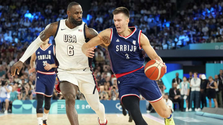 Aug 8, 2024; Paris, France; Serbia centre Filip Petrusev (3) drives to the basket while defended by United States guard LeBron James (6) during the first half in a men's basketball semifinal game during the Paris 2024 Olympic Summer Games at Accor Arena. Mandatory Credit: Kyle Terada-USA TODAY Sports