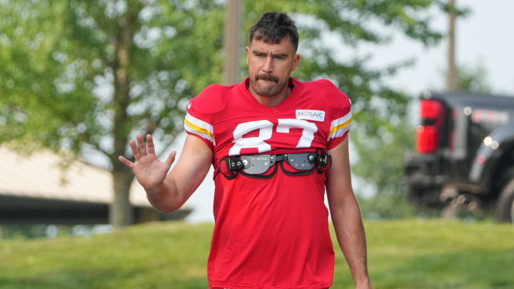 Jul 26, 2024; Kansas City, MO, USA; Kansas City Chiefs tight end Travis Kelce (87) waves to fans as he walks down the hill from the locker room to the fields prior to training camp at Missouri Western State University. Mandatory Credit: Denny Medley-USA TODAY Sports