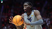 Mar 4, 2025; Salt Lake City, Utah, USA; West Virginia Mountaineers center Eduardo Andre passes the ball against the Utah Utes during the first half at Jon M. Huntsman Center. Mandatory Credit: Rob Gray-Imagn Images
