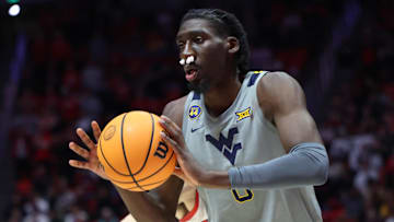 Mar 4, 2025; Salt Lake City, Utah, USA; West Virginia Mountaineers center Eduardo Andre passes the ball against the Utah Utes during the first half at Jon M. Huntsman Center. Mandatory Credit: Rob Gray-Imagn Images