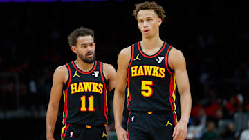 Trae Young #11 and Dyson Daniels #5 of the Atlanta Hawks look on against the Denver Nuggets.