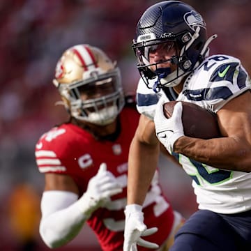 Dec 10, 2023; Santa Clara, California, USA; Seattle Seahawks running back Zach Charbonnet (26) runs past San Francisco 49ers linebacker Fred Warner (54) in the first quarter at Levi's Stadium. Mandatory Credit: Cary Edmondson-Imagn Images