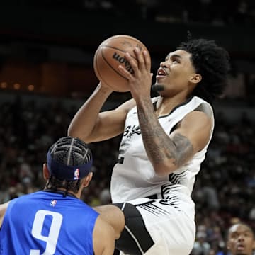 Jul 12, 2025; Las Vegas, NV, USA; San Antonio Spurs guard Dylan Harper (2) shoots against Dallas Mavericks guard Ryan Nembhard (9) in the first quarter of their game at Thomas & Mack Center. Mandatory Credit: Candice Ward-Imagn Images