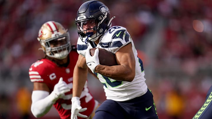 Dec 10, 2023; Santa Clara, California, USA; Seattle Seahawks running back Zach Charbonnet (26) runs past San Francisco 49ers linebacker Fred Warner (54) in the first quarter at Levi's Stadium. Mandatory Credit: Cary Edmondson-Imagn Images