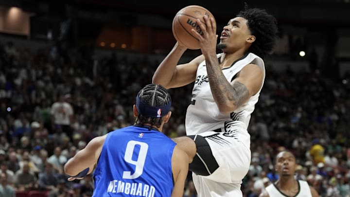 Jul 12, 2025; Las Vegas, NV, USA; San Antonio Spurs guard Dylan Harper shoots against Dallas Mavericks guard Ryan Nembhard in the first quarter of their game at Thomas & Mack Center