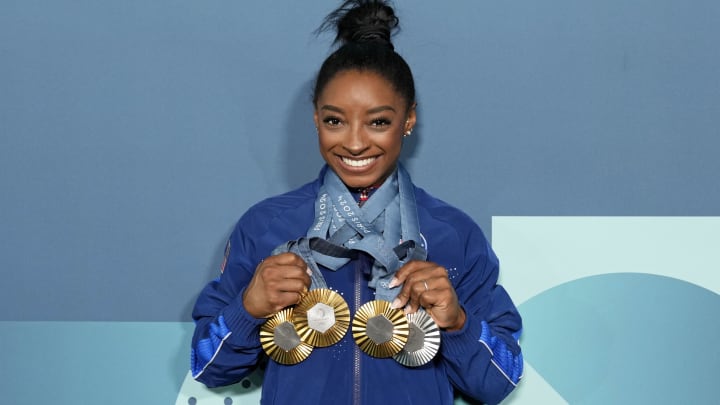 Aug 5, 2024; Paris, France; Simone Biles of the United States poses for a photo with her three gold and one silver medal after day three of the gymnastics event finals during the Paris 2024 Olympic Summer Games. 