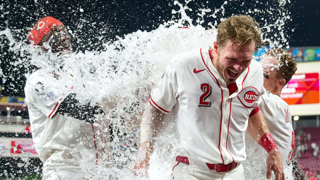 Cincinnati Reds pinch hitter Gavin Lux (2) receives an ice bath from Elly De La Cruz and Matt McLain after hitting a walk-off line drive for a Reds win in the bottom of the 11th inning of the MLB interleague game between the Cincinnati Reds and the New York Yankees at Great American Ball Park in downtown Cincinnati on Tuesday, June 24, 2025. The Reds won 5-4 in 11 innings.