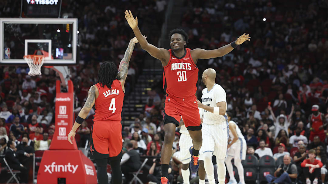 Apr 12, 2026; Houston, Texas, USA; Houston Rockets center Clint Capela (30) celebrates with guard JD Davison (4) after a play during the fourth quarter against the Memphis Grizzlies at Toyota Center. Mandatory Credit: Troy Taormina-Imagn Images