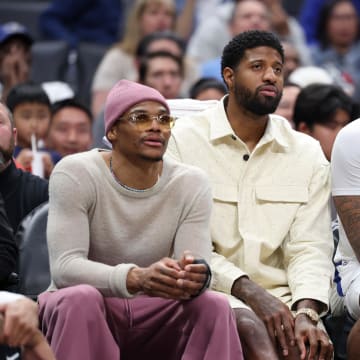 Mar 10, 2024; Los Angeles, California, USA;  Los Angeles Clippers guard Russell Westbrook (left) and forward Paul George (second from left) watch the game from the bench during the second half against the Milwaukee Bucks at Crypto.com Arena. Mandatory Credit: Kiyoshi Mio-USA TODAY Sports