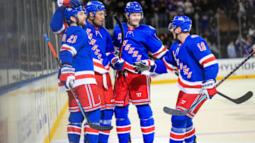 Feb 17, 2022; New York, New York, USA; New York Rangers defenseman K'Andre Miller (79) celebrates his goal with defenseman Jacob Trouba (8), center Barclay Goodrow (21) and center Ryan Strome (16) during the second period against the Detroit Red Wings at Madison Square Garden. Mandatory Credit: Danny Wild-Imagn Images