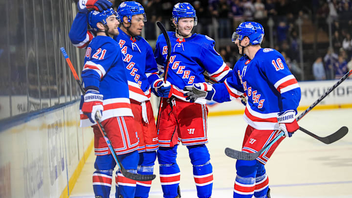 Feb 17, 2022; New York, New York, USA; New York Rangers defenseman K'Andre Miller (79) celebrates his goal with defenseman Jacob Trouba (8), center Barclay Goodrow (21) and center Ryan Strome (16) during the second period against the Detroit Red Wings at Madison Square Garden. Mandatory Credit: Danny Wild-Imagn Images