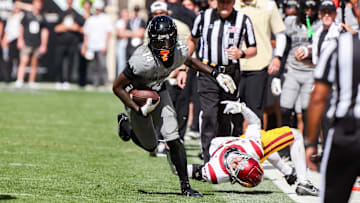 Sep 30, 2023; Boulder, Colorado, USA; Colorado Buffaloes wide receiver Omarion Miller (14) breaks a tackle by USC Trojans safety Bryson Shaw (27) at Folsom Field. Mandatory Credit: Chet Strange-Imagn Images