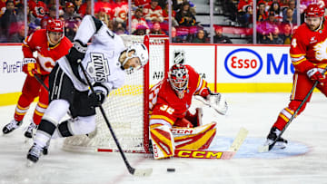 Nov 11, 2024; Calgary, Alberta, CAN; Calgary Flames goaltender Dustin Wolf (32) guards his net against Los Angeles Kings left wing Warren Foegele (37) during the third period at Scotiabank Saddledome. Mandatory Credit: Sergei Belski-Imagn Images