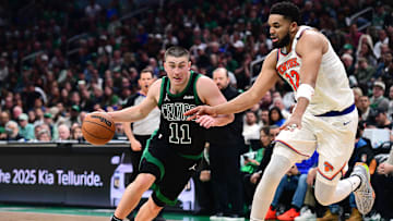 May 14, 2025; Boston, Massachusetts, USA; Boston Celtics guard Payton Pritchard (11) controls the ball while New York Knicks center Karl-Anthony Towns (32) defends in the second half during game five of the second round for the 2025 NBA Playoffs at TD Garden. Mandatory Credit: Bob DeChiara-Imagn Images