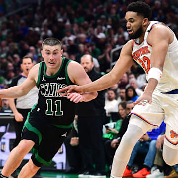 May 14, 2025; Boston, Massachusetts, USA; Boston Celtics guard Payton Pritchard (11) controls the ball while New York Knicks center Karl-Anthony Towns (32) defends in the second half during game five of the second round for the 2025 NBA Playoffs at TD Garden. Mandatory Credit: Bob DeChiara-Imagn Images