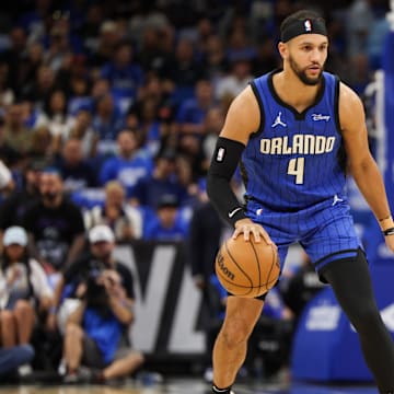 Orlando Magic guard Jalen Suggs (4) controls the ball from Cleveland Cavaliers guard Donovan Mitchell (45) in the first quarter during game four of the first round for the 2024 NBA playoffs at Kia Center.