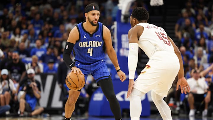 Orlando Magic guard Jalen Suggs (4) controls the ball from Cleveland Cavaliers guard Donovan Mitchell (45) in the first quarter during game four of the first round for the 2024 NBA playoffs at Kia Center.