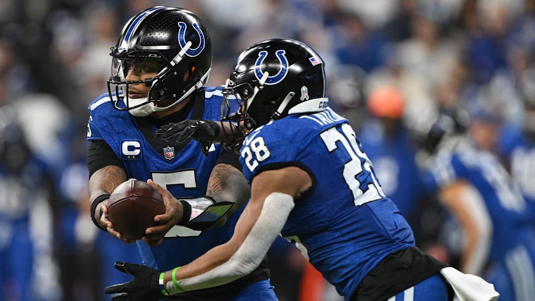 Nov 24, 2024; Indianapolis, Indiana, USA; Indianapolis Colts quarterback Anthony Richardson (5) hands the ball off to Indianapolis Colts running back Jonathan Taylor (28) during the second quarter against the Detroit Lions at Lucas Oil Stadium. Mandatory Credit: Marc Lebryk-Imagn Images