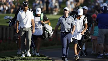 Mar 13, 2025; Ponte Vedra Beach, Florida, USA; Xander Schauffele, left, and Rory Mcllroy walk to the seventeenth green during the first round of The Players Championship golf tournament at TPC Sawgrass. Mandatory Credit: Jeff Swinger-Imagn Images