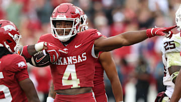 Arkansas Razorbacks running back Mike Washington Jr (4) celebrates after rushing for a first down in the second quarter against the Texas A&M Aggies at Donald W. Reynolds Razorback Stadium.