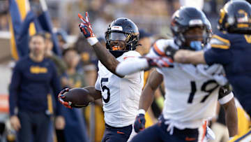 Virginia linebacker Kam Robinson runs back a pick-six against Cal. The Cavaliers are currently projected as the ACC runner-up.