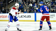 Nov 30, 2024; New York, New York, USA; Montreal Canadiens right wing Josh Anderson (17) and New York Rangers defenseman Jacob Trouba (8) fight during the first period at Madison Square Garden. Mandatory Credit: John Jones-Imagn Images