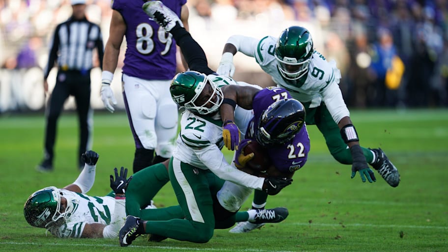 Baltimore Ravens running back Derrick Henry is tackled by New York Jets safety Tony Adams.