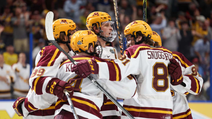Apr 6, 2023; Tampa, Florida, USA; Minnesota defenseman Mike Koster (4) is congratulated by forward Minnesota forward Jimmy Snuggerud (81) after scoring a goal against Boston University in the first period in the semifinals of the 2023 Frozen Four college ice hockey tournament at Amalie Arena. Mandatory Credit: Nathan Ray Seebeck-USA TODAY Sports