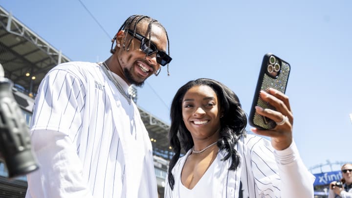 Apr 13, 2024; Chicago, Illinois, USA; Chicago Bears safety Jonathan Owens and American gymnast Simone Biles take a selfie prior to a game between the Chicago White Sox and the Cincinnati Reds at Guaranteed Rate Field. 