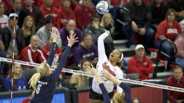 Dec 9, 2016; Lincoln, NE, USA;  Nebraska Cornhuskers Briana Holman (13) spikes the ball against Penn State Nittany Lions Ali Frantti (5) and Tori Morrell (11) at Bob Devaney Sports Center.