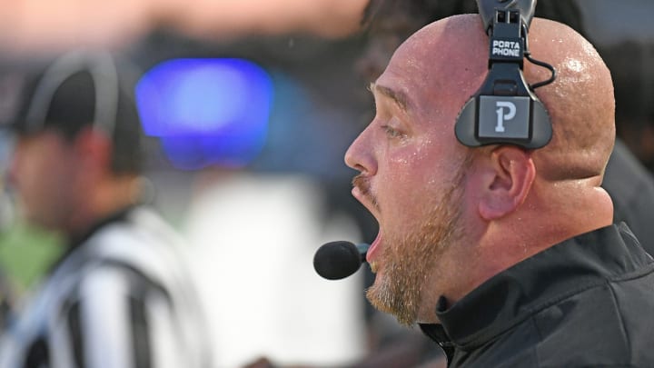 Booker (Florida) head coach Scottie Littles barks out plays during a 24-20 loss Cardinal Mooney High School in 2023 spring game in Sarasota.