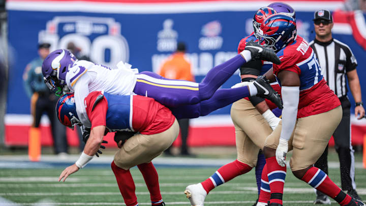 Greenard hits Jones during the first half at MetLife Stadium.