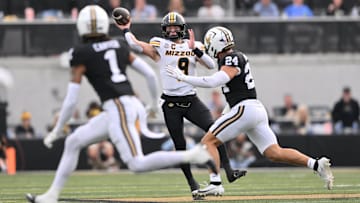 Oct 25, 2025; Nashville, Tennessee, USA; Missouri Tigers quarterback Beau Pribula (9) throws while pressured by Vanderbilt Commodores defensive lineman Nick Rinaldi (24) during the second quarter at FirstBank Stadium. Mandatory Credit: Steve Roberts-Imagn Images