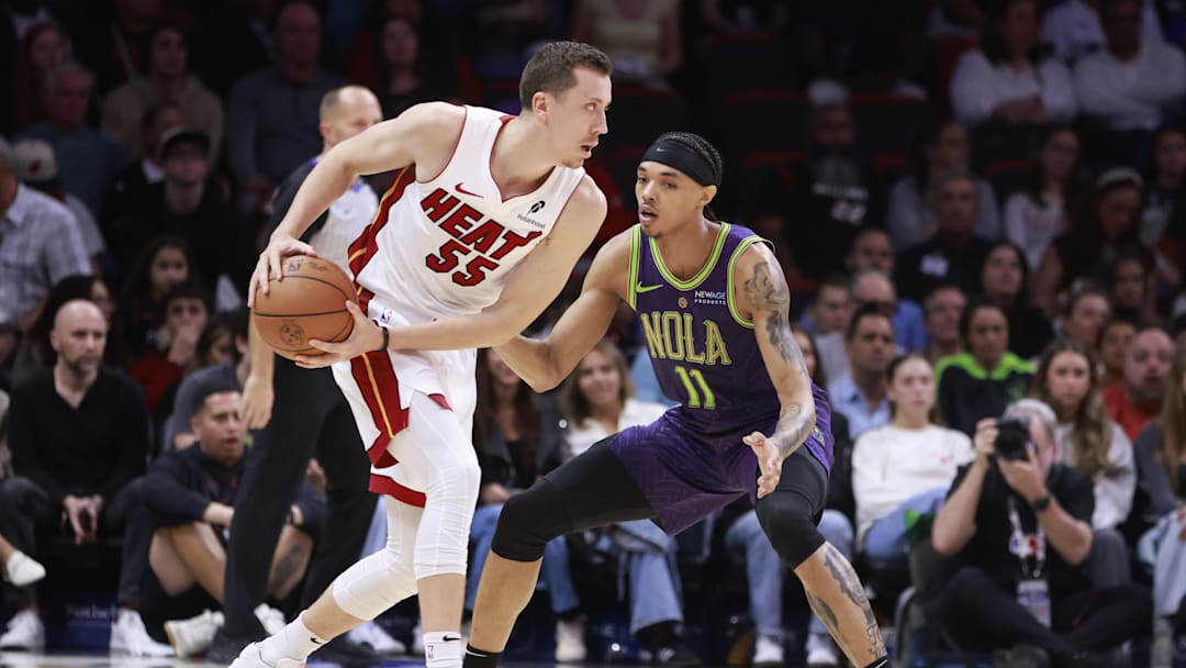Jan 1, 2025; Miami, Florida, USA;  New Orleans Pelicans guard Brandon Boston (11) defends Miami Heat forward Duncan Robinson (55) during the first half at Kaseya Center. Mandatory Credit: Rhona Wise-Imagn Images